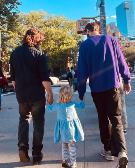 Norman Reedus, his son and his daughter walking on the streets.